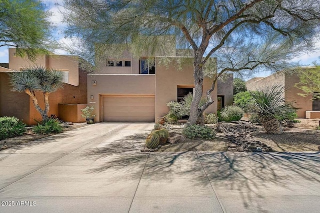 27892 N 108th Way, Scottsdale, AZ 85262 - pueblo-style home featuring driveway, an attached garage, and stucco siding