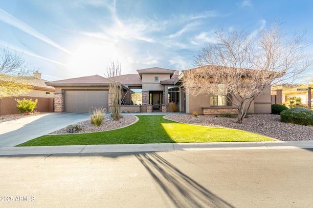 view of front of home with a front yard and a garage