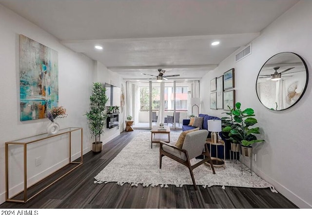 living room with ceiling fan and dark hardwood / wood-style floors