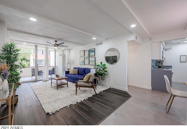 living room with light hardwood / wood-style floors and ceiling fan