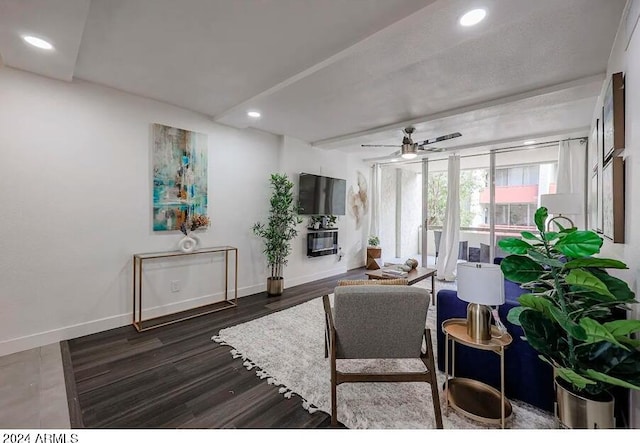 living room featuring dark wood-type flooring and ceiling fan