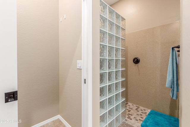 full bathroom featuring baseboards and walk in shower