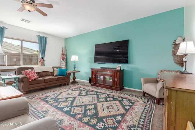 living room with visible vents, baseboards, and ceiling fan