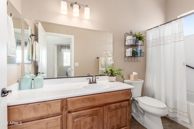 bathroom with a wealth of natural light, toilet, shower / tub combo with curtain, and vanity