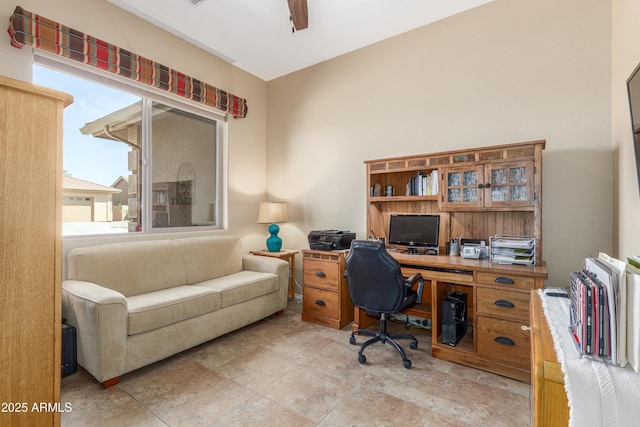 home office with plenty of natural light and ceiling fan