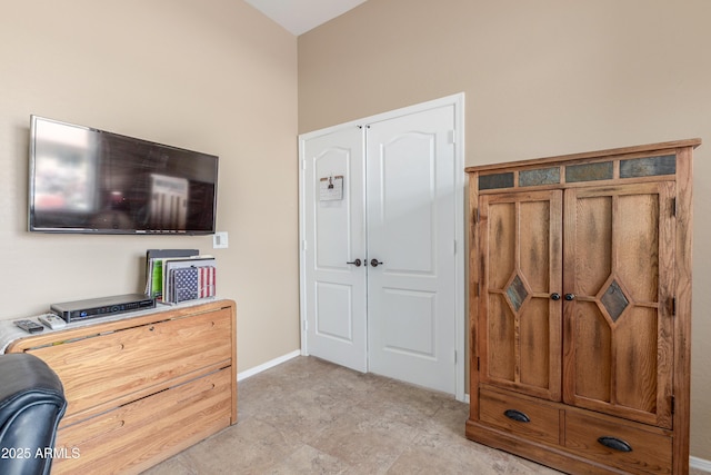 bedroom with a closet and baseboards