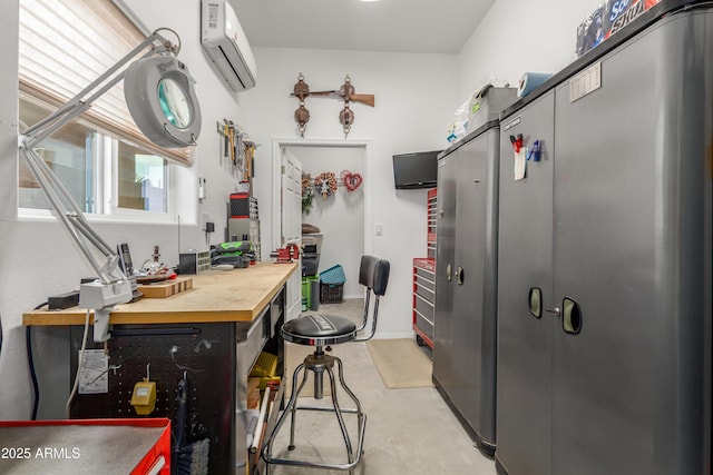 kitchen with wooden counters, concrete floors, and a wall unit AC