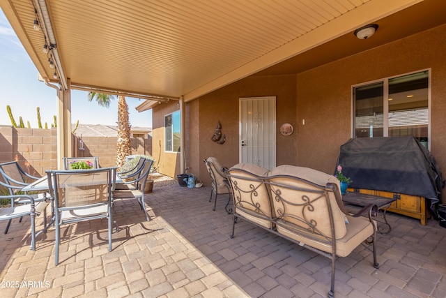 view of patio featuring outdoor dining space, area for grilling, and fence