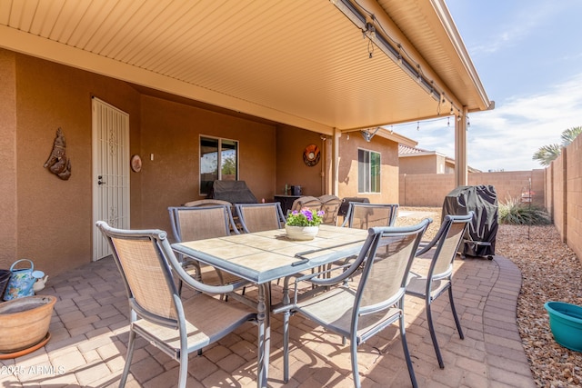 view of patio / terrace featuring area for grilling, outdoor dining area, and a fenced backyard