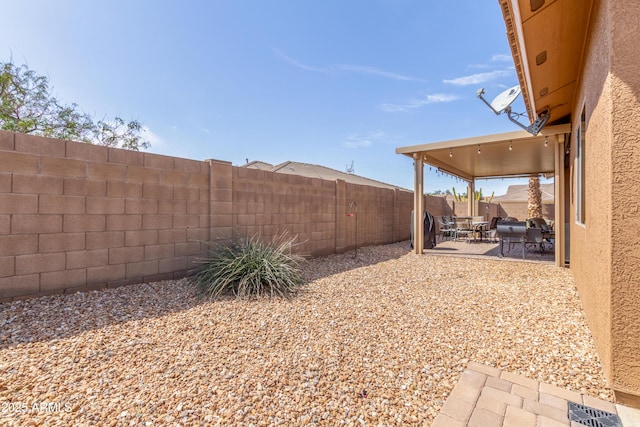 view of yard featuring visible vents, a patio, and a fenced backyard