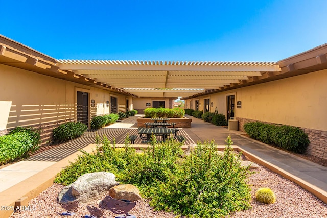 view of patio featuring fence and a pergola