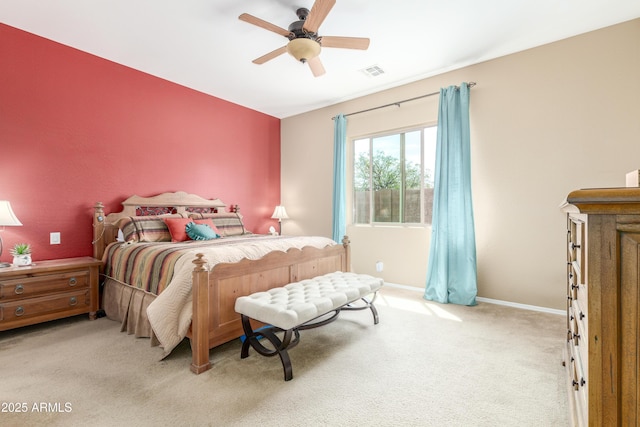 bedroom featuring light carpet, visible vents, a ceiling fan, and baseboards