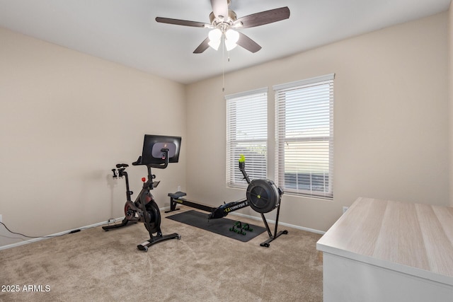 workout area with ceiling fan and light carpet