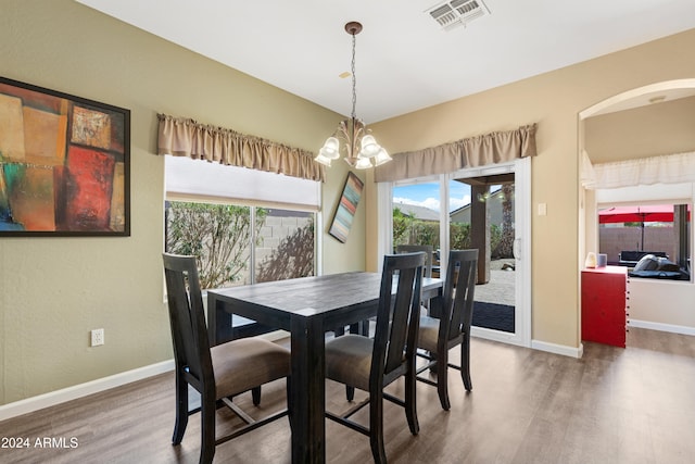 dining room with wood-type flooring and a chandelier