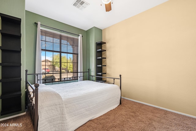 bedroom with ceiling fan and dark colored carpet