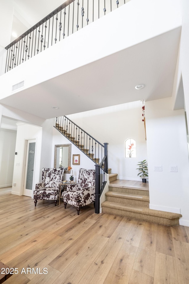 20639 W Grandview Dr, Buckeye, AZ 85396 - staircase with hardwood / wood-style floors, a high ceiling, and baseboards