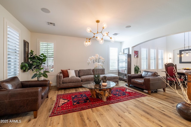 20639 W Grandview Dr, Buckeye, AZ 85396 - living room with a chandelier, wood finished floors, and healthy amount of natural light