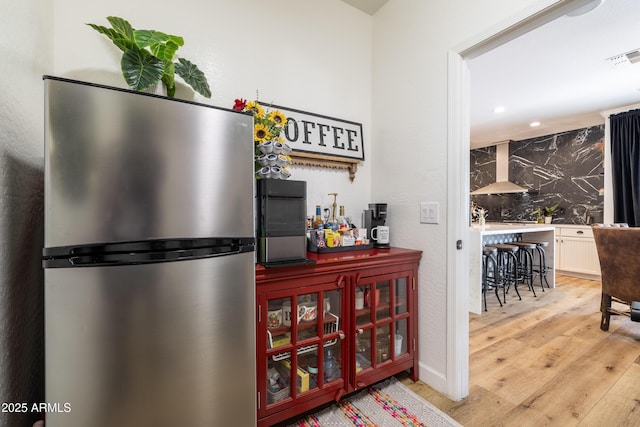 20639 W Grandview Dr, Buckeye, AZ 85396 - bar featuring wall chimney exhaust hood, freestanding refrigerator, wood finished floors, and recessed lighting
