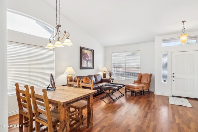 dining room with dark hardwood / wood-style flooring and vaulted ceiling