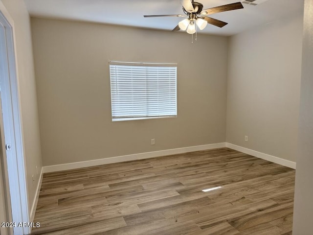 empty room featuring hardwood / wood-style flooring and ceiling fan