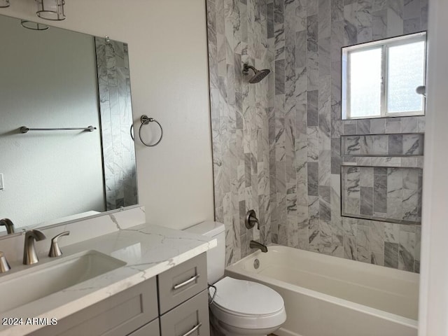 full bathroom featuring toilet, vanity, and tiled shower / bath combo