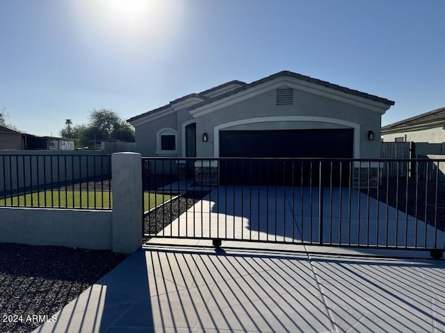 view of gate with a lawn and a garage