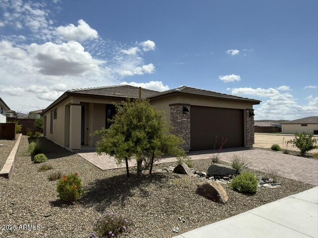 4509 Charro Ct, Wickenburg, AZ 85390 - view of front of property with decorative driveway, a garage, stucco siding, and a tile roof