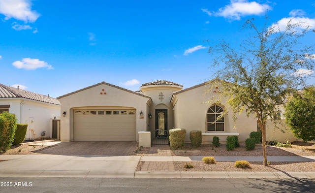 mediterranean / spanish-style house with a garage