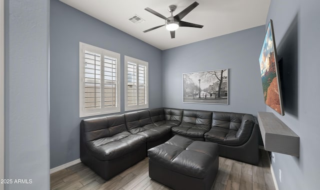 living room featuring ceiling fan and light hardwood / wood-style floors