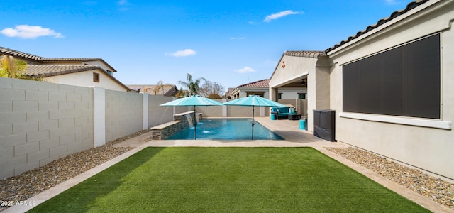 view of swimming pool featuring a patio, a yard, and pool water feature