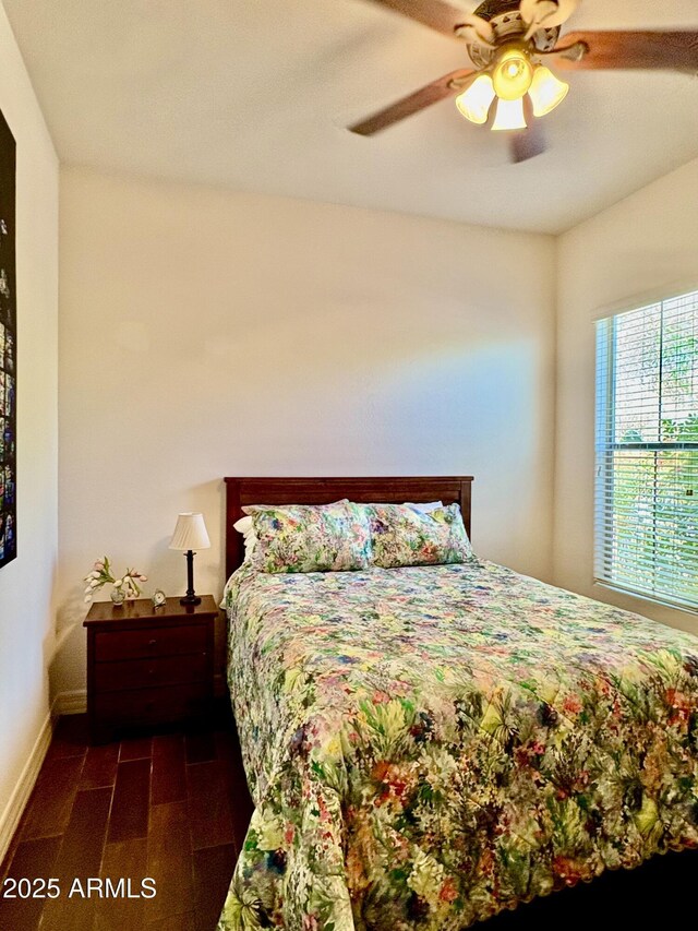 9249 E Desert Arroyos St, Scottsdale, AZ 85255 - bedroom with wood tiled floors, baseboards, and a ceiling fan