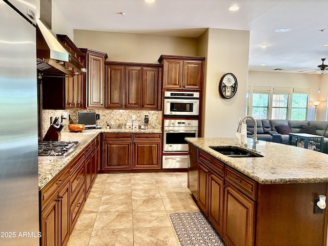 9249 E Desert Arroyos St, Scottsdale, AZ 85255 - kitchen featuring a sink, stainless steel appliances, a warming drawer, backsplash, and wall chimney range hood