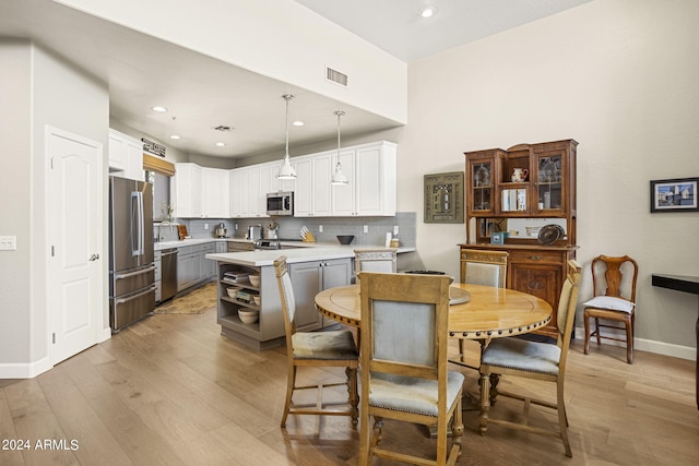 dining space featuring light wood-type flooring