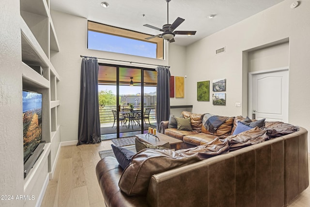 living room with ceiling fan and light hardwood / wood-style floors