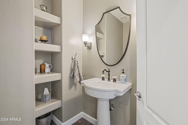 bathroom featuring hardwood / wood-style floors and built in features