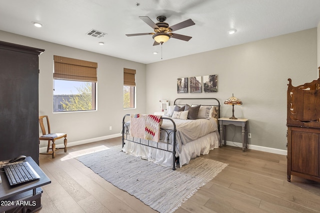 bedroom with light hardwood / wood-style flooring and ceiling fan