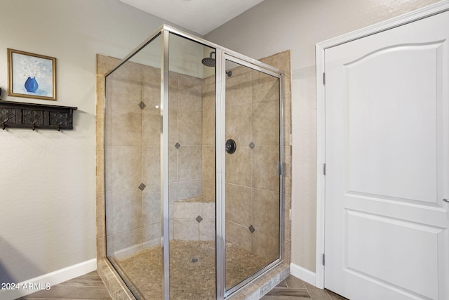 bathroom with a shower with shower door