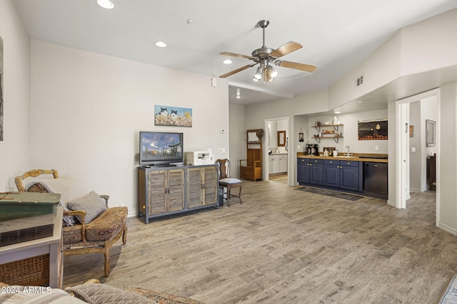 living room with indoor wet bar, hardwood / wood-style flooring, and ceiling fan