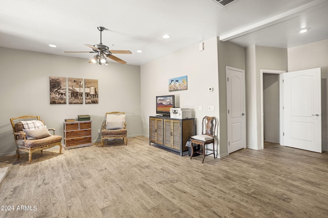 sitting room with wood-type flooring and ceiling fan