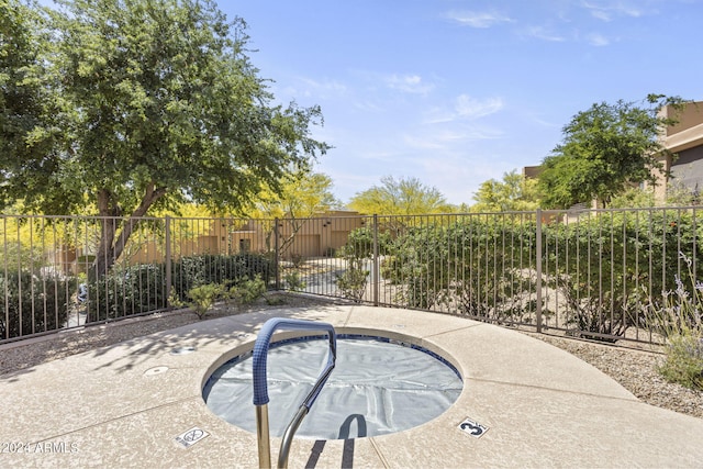 view of swimming pool with a community hot tub