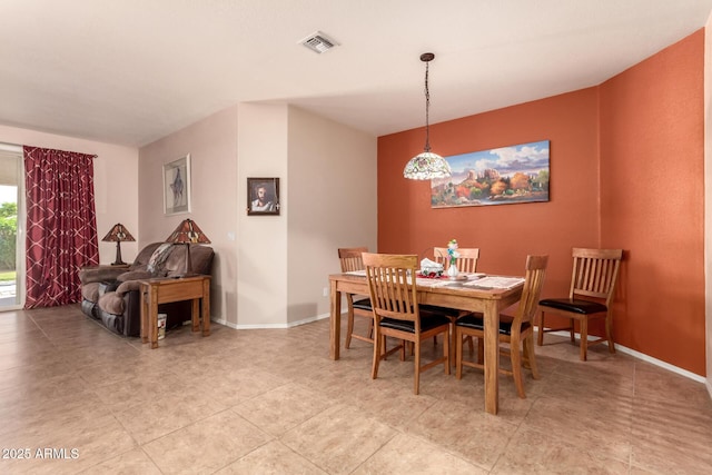 dining area featuring baseboards