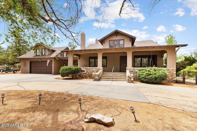 2877 Iron Springs Rd, Prescott, AZ 86305 - view of front of home featuring covered porch, stucco siding, a chimney, and driveway