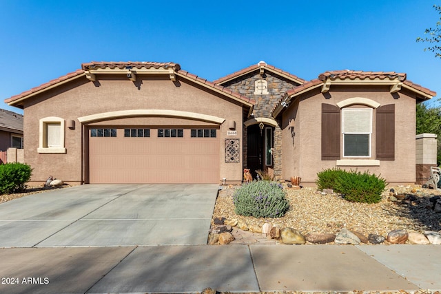 mediterranean / spanish-style home with a garage