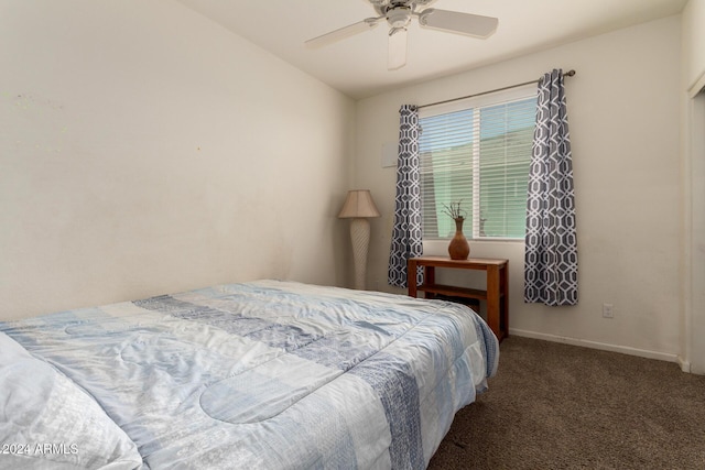 carpeted bedroom with ceiling fan and vaulted ceiling