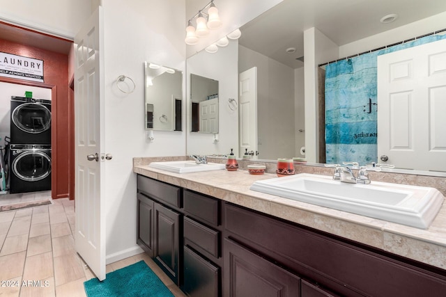 bathroom with vanity, stacked washing maching and dryer, and curtained shower