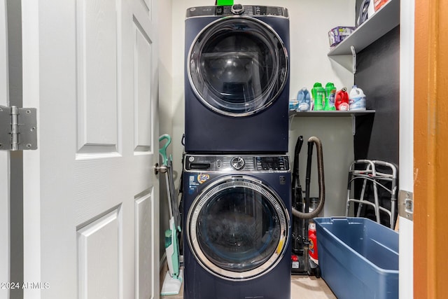 washroom featuring stacked washer and clothes dryer