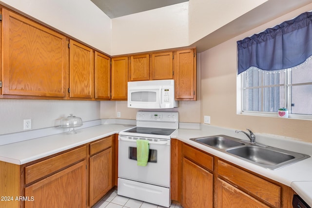 kitchen with brown cabinets, a sink, white appliances, light tile patterned flooring, and light countertops