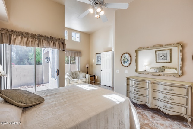 bedroom featuring a towering ceiling, access to outside, and ceiling fan