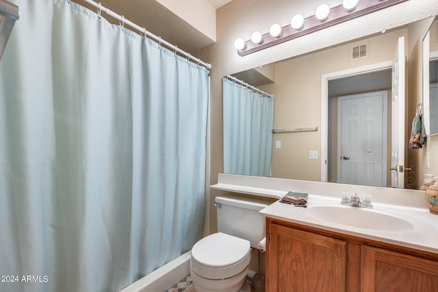 bathroom featuring vanity, toilet, and a shower with curtain