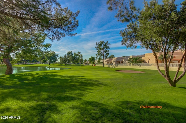 view of community with a yard and a water view